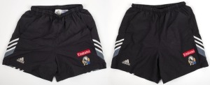 Nathan Buckley’s Collingwood training shorts circa 2003. Adidas logo on right, Collingwood logo on left with Emirates patch above. Black shorts with grey, black and white angled striping (2 pairs; different sizes).