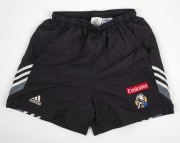 Nathan Buckley’s Collingwood training shorts circa 2003. Adidas logo on right, Collingwood logo on left with Emirates patch above. Black shorts with grey, black and white angled striping (2 pairs; different sizes). - 2