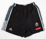 Nathan Buckley’s Collingwood training shorts, early 2000s. Adidas logo on right, Collingwood logo on left with Emirates patch below. Black shorts with grey panel with white stripes along edge. (2 pairs, different sizes). - 2