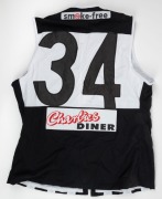 2001 Port Adelaide guernsey, #34. Lace-up guernsey bearing Buckley&rsquo;s old #34, given to him as a souvenir upon his return to the club for a visit, most likely the 1992 Premiership 10-year reunion. Maughan Thiem Ford and Pro Paint n Panel sponsor patches on - 2