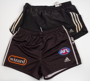 Nathan Buckley’s Collingwood playing shorts, circa 2006-07. Black shorts with Wizard branding on front; also, a pair of Buckley’s adidas training shorts - black with white stripes. (2 items).