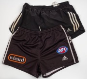 Nathan Buckley&rsquo;s Collingwood playing shorts, circa 2006-07. Black shorts with Wizard branding on front; also, a pair of Buckley&rsquo;s adidas training shorts - black with white stripes. (2 items).