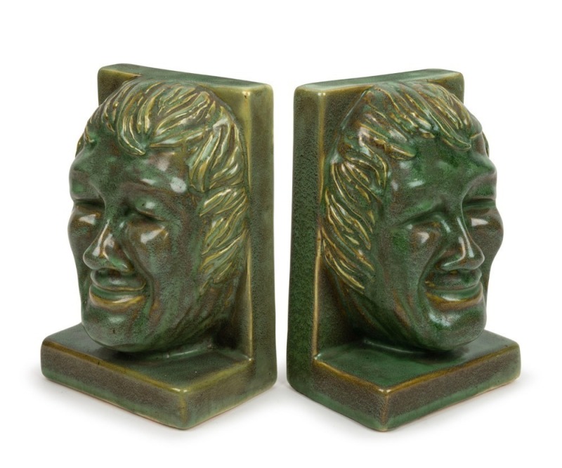 MELROSE WARE pair of green glazed face mask bookends, stamped "Melrose Ware, Australian", ​​​​​​​18cm high