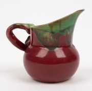 REMUED early pottery jug with applied gumnut and leaf with branch handle, unusually dark pink and green colourway, incised "Remued" with circular black ink stamp, ​​​​​​​10.5cm high - 2