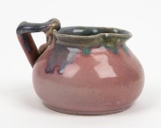 REMUED pottery jug with applied gumnut, leaf and branch handle, glazed in pink, mauve and green, incised "Remued 173/SM, Hand Made", 8cm high, 11cm wide - 2