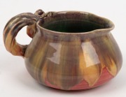 REMUED pottery jug with applied gumnuts, leaf and branch handle, unusual pink, mauve and mustard glaze with green interior, incised "Remued", 7cm high, 13cm wide - 3