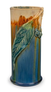 REMUED cylindrical pottery vase with applied gumnuts and leaf, glazed in blue, cream and orange, incised "Remued, 145/9M", 21cm high