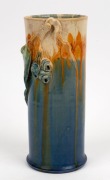 REMUED cylindrical pottery vase with applied gumnuts and leaf, glazed in blue, cream and orange, incised "Remued, 145/9M", 21cm high - 2