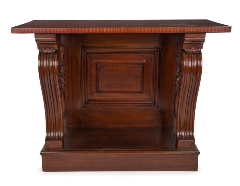 An antique Australian cedar consol table with fluted and carved scrolling supports and panelled back, 19th century, 96cm high, 127cm wide, 58cm deep