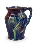 REMUED rare pottery jug adorned with koala, gumnuts and leaves, branch handle and koala scratch marks, glazed in blue and green with pink highlights, the only example seen in our rooms, incised "Remued", 34cm high