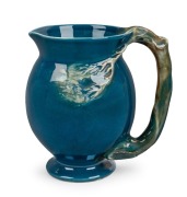 CRUFFEL Australian porcelain jug with windswept tree handle and decoration glazed in blue and green, 13cm high