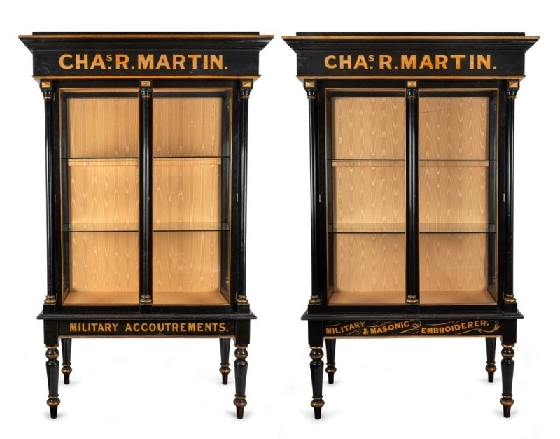 CHARLES R. MARTIN "MILITARY ACCOUTREMENTS" historically important stunning pair of ebonized and gilt display cabinets from the 1888 MELBOURNE EXHIBITION, with accompanying silk embroidered banner and Australian cedar hand-painted advertising wall plaque,