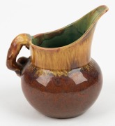 REMUED pottery jug with applied gumnut, leaf and branch handle, glazed in brown and green with pink highlights, incised "Remued", 10.5cm high - 2