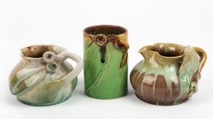 REMUED pottery vase and two pottery jugs, all with applied gumnuts and leaves, (3 items), incised signatures to bases, the largest 10.5cm high