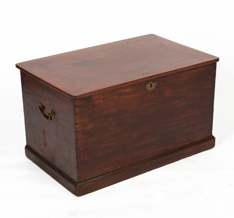 An Australian cedar flip-top trunk with dovetailed joinery, brass carry handles and a moulded plinth base, 19th century, 46cm high, 79cm wide, 50cm deep