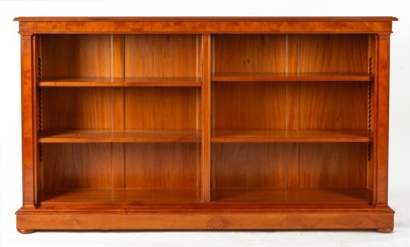 Australian huon pine double bay open bookcase with fully adjustable shelves, flanking pilasters, moulded top, conforming plinth base and bun feet, 20th century, ​​​​​​​107cm high, 184cm wide, 38.5cm deep