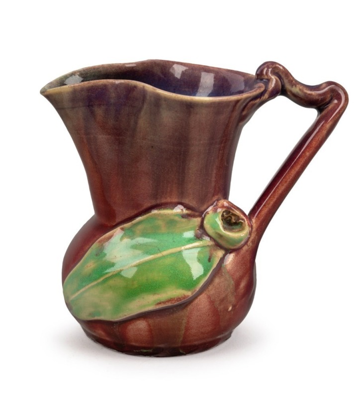 REMUED pottery jug with applied gumnut and leaf, glazed in pink with lime green highlights, incised "Remued, Hand Made, 118M", 12cm high