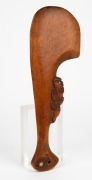 A Maori patu, carved wood with paua shell decoration, New Zealand origin, 20th century, 40.5cm long - 2