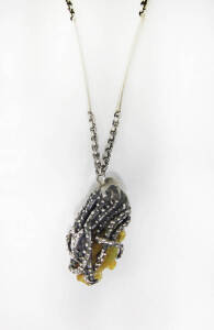 COLLAR: Sterling silver collar with octopus pendant grasping a raw mineral specimen. C.1970's.