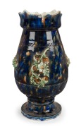 A Colonial Australian pottery urn with mottled blue and brown glaze and applied green floral decoration, 19th century, ​​​​​​​33cm high