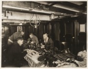 THE B.A.N.Z. ANTARCTIC EXPEDITION:Official original photograph by Captain Frank Hurley:Image A6 - Title: Classifying the treasures,with official "MAWSON ANTARCTIC EXPEDITION" handstamp and release date "THURSDAY FEB.13, 1930" verso, together with the offi