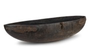 An impressive Massim canoe shaped bowl, carved wood with remains of piped clay, East Papua New Guinea, ​​​​​​​112.5cm wide