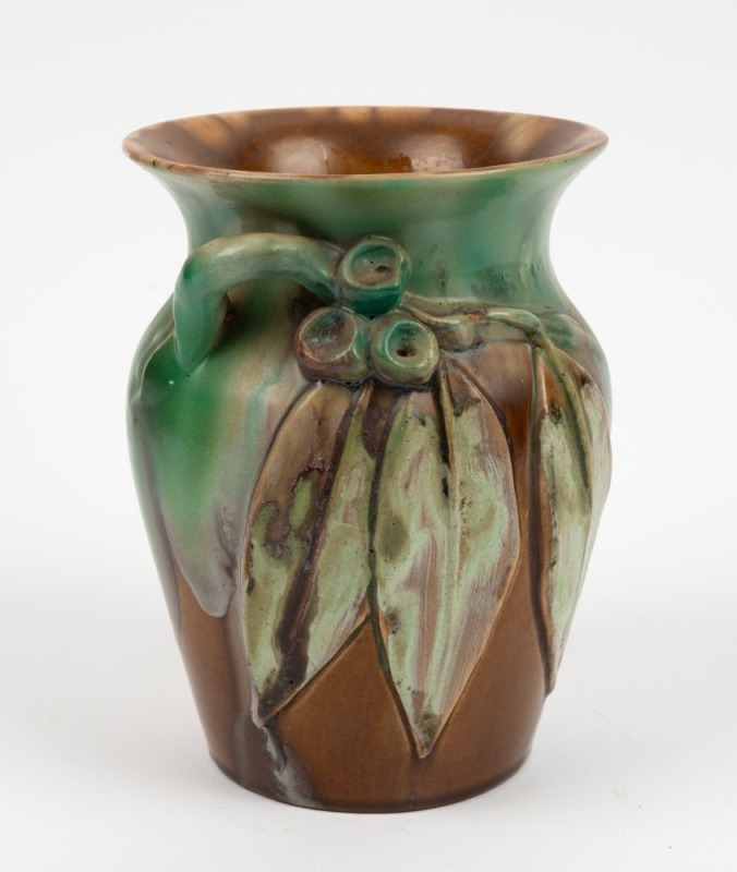 REMUED green and brown glazed pottery vase with applied gumnuts and leaves, incised "Remued, Hand Made", 19cm high