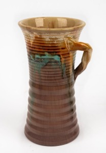 REMUED ribbed pottery vase with branch handle, incised "Remued 262/9", 26cm high