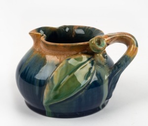 REMUED pottery jug glazed in brown and green with applied gumnuts, leaf & branch handle, incised "Remued 173SM", 8cm high, 12.5cm wide