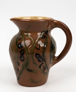 FLORENZ POTTERY brown glazed pottery jug with incised Aboriginal boomerang motif, signed "Florenz", 19cm high