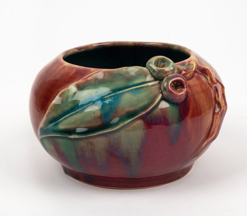 REMUED pottery vase with applied gumnuts and leaf, glazed in vibrant pink and green with blue interior, incised "Remued, Hand Made", 11cm high, 17cm wide