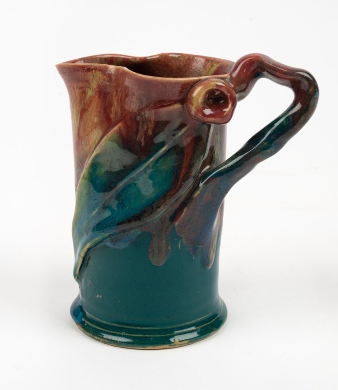 PAMELA pottery jug with applied branch handle, gumnut and leaf, glazed in unusual green and pink colourway, incised "Pamela, Hand Made, 1934", 13.5cm high