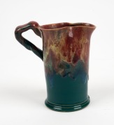 PAMELA pottery jug with applied branch handle, gumnut and leaf, glazed in unusual green and pink colourway, incised "Pamela, Hand Made, 1934", 13.5cm high - 2