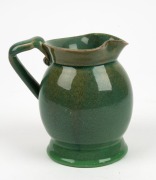 REMUED rare green glazed pottery jug with applied branch handle, gumnuts and leaf, incised "Remued, Hand Made, 166M", 14cm high - 2