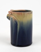 REMUED cylindrical pottery vase with applied gumnuts and leaf, glazed in blue and cream with pink highlights, incised "Remued, Hand Made", 10cm high - 2