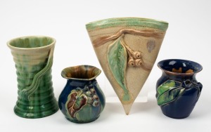 REMUED pottery wall pocket with gumnuts and leaves, a blue and green glazed vase with gumnut and leaf, a green glazed vase with ribbed handle, and a blue and green glazed vase with applied grapes and leaf, (4 items), all incised "Remued", the wall pocket 