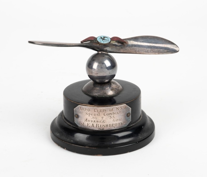 "AERO CLUB OF N.S.W, Speed Contest. 20.7.35. ADVANCE GDE. 1st E. A. RUSHBROOKE" sterling silver plaque affixed to the front of an attractive trophy presented by the Aero Club of New South Wales, ​​​​​​​8cm high overall