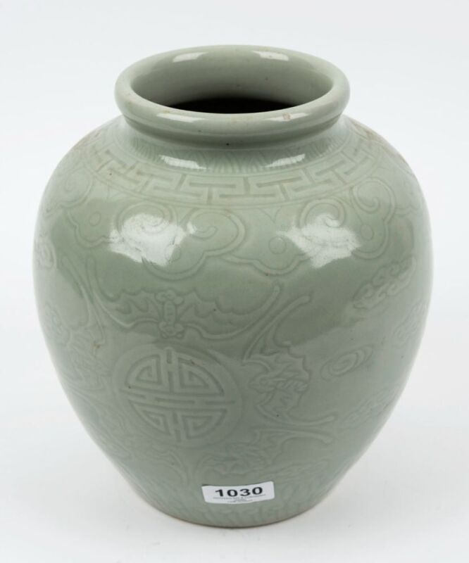 A Chinese celadon porcelain vase with incised shou symbols together with flying bats and Ruyi decoration on the shoulder, early 20th century, 25cm high