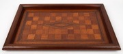 An Australian checkerboard top marquetry serving tray, timbers include silky oak, grevillea, cedar, rainforest walnut, maple and others, Queensland origin, early 20th century, ​​​​​​​55cm wide