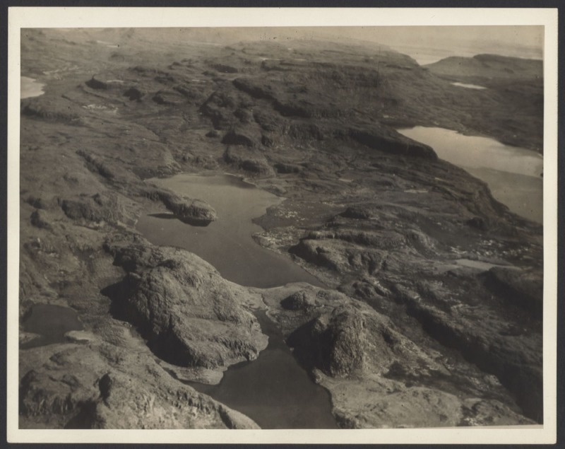 THE B.A.N.Z. ANTARCTIC EXPEDITION: Official original photograph by Captain Frank Hurley: Image A64 - Title: The Unexplored Heart of Kerguelen, with official "MAWSON ANTARCTIC EXPEDITION" handstamp and release date "MONDAY MAY 12, 1930" verso, together wit