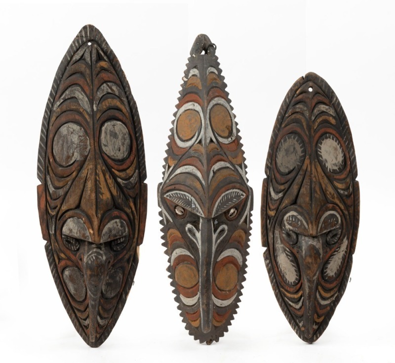 Three tribal masks, carved wood and shell with painted finish, Papua New Guinea, ​​​​​​​the largest 47cm high