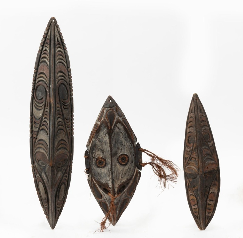 Three tribal masks, carved wood and fibre with painted finish, Papua New Guinea, ​​​​​​​the largest 60cm high