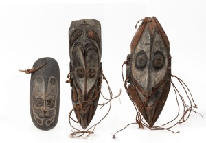 Three tribal masks, carved and fibre with remains of painted finish, Papua New Guinea origin, ​​​​​​​the largest 39cm high