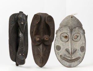 Three tribal masks, carved and shell with remains of painted finish, Papua New Guinea origin, ​​​​​​​the largest 44cm high