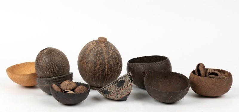 Assorted carved coconut tribal food bowls and water container, together with a group of nut beads, Papua New Guinea origin, (9 items), ​​​​​​​the water container 12cm high