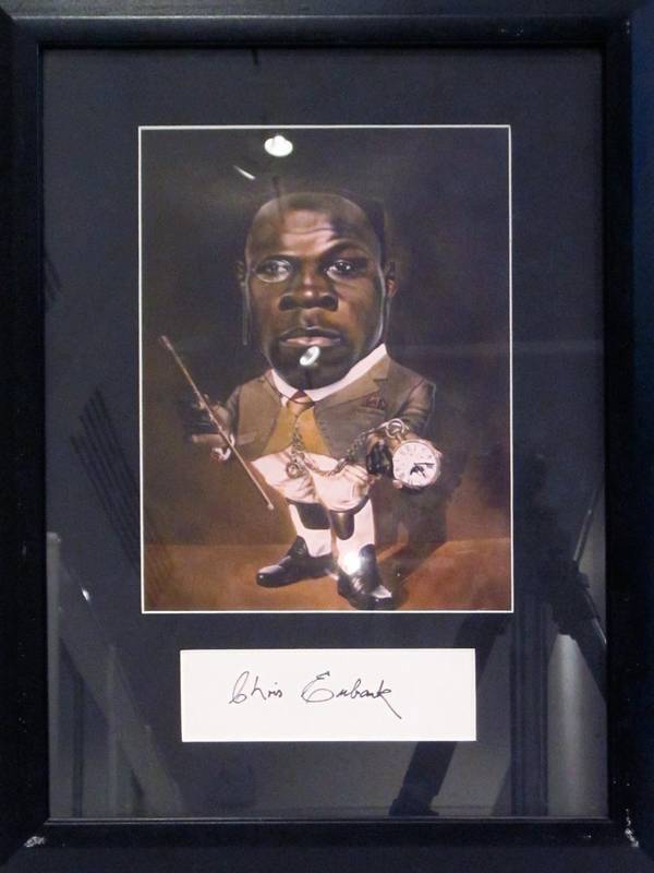 CHRIS EUBANK, display comprising signature on piece, window mounted with picture, framed & glazed, overall 35x45cm.