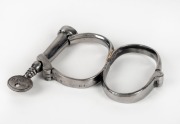 Figure 8 nickel plated handcuffs with key, 20th century, ​​​​​​​13.5cm wide