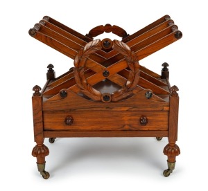 An antique English Regency rosewood music canterbury of Louden design with carved wreath decoration and single drawer, bearing original paper label from "The Right Honourable Lord Broughton G.C.B.", circa 1835, 54cm high, 54cm wide, 41cm deep.