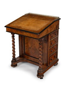 An antique English figured walnut Davenport with ebonised mouldings, barley twist supports and four graduated drawers. Satin birch fitted interior and tooled leather writing slope below an ormolu gallery, circa 1870. 80cm high, 60cm wide, 61cm deep.