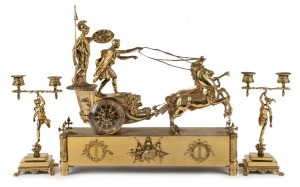 An antique French brass-cased figural mantle clock with chariot scene, eight day time and bell striking movement with applied enamel Roman numerals, retailed by HOWARD & Co. of New York, late 19th century, together with a pair of figural candelabra garnitures, (3 items), 45cm high, 51cm wide